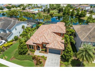 Stunning aerial view of a beautiful house with a tile roof and landscaped yard at 12014 Perennial Pl, Lakewood Ranch, FL 34211