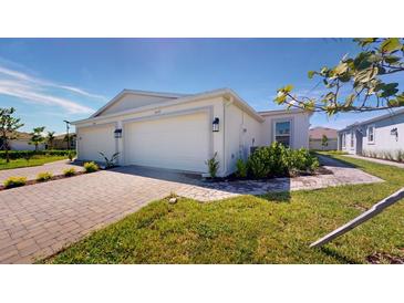 Two-car garage and front yard with landscaping at 16132 Ivy Ridge Ct, Port Charlotte, FL 33953