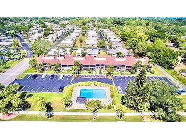 Community overview, showing homes, landscaping, and a pool at 5408 Swift Rd # 28, Sarasota, FL 34231