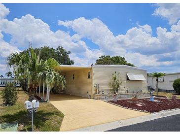 Charming single-story home featuring a well-maintained yard, covered parking, and bright exterior paint at 407 White Oak Way, Sarasota, FL 34237