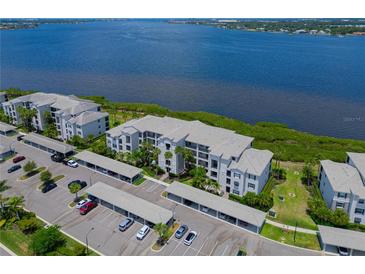 Aerial view of waterfront condo building with parking at 1020 Tidewater Shores Loop # 108, Bradenton, FL 34208