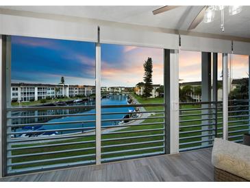 Balcony with sliding glass doors offers stunning sunset views over the canal at 4350 Chatham Dr # E307, Longboat Key, FL 34228