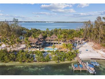 Island home with private beach, pool, and dock at 7147 La Lenaire Dr, Longboat Key, FL 34228