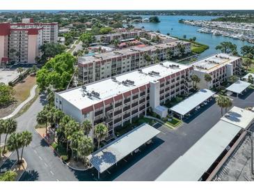 Aerial view of condo building with parking and waterfront access at 220 Santa Maria St # 240, Venice, FL 34285