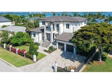 Luxury waterfront home with a large driveway and beautifully landscaped yard at 121 Seagull Ln, Sarasota, FL 34236