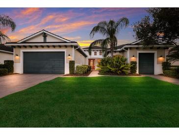 Two-car garage, well-manicured lawn, and appealing facade at 5209 Lake Overlook Ave, Bradenton, FL 34208