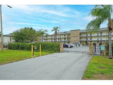 Exterior view of a two-story building with gated entrance at 6100 12Th S St # 220, St Petersburg, FL 33705