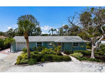 Charming, light-blue single-story home with mature landscaping and paver walkway at 506 69Th St, Holmes Beach, FL 34217