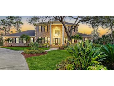 Charming brick home with a lush green lawn, tasteful landscaping, and a welcoming front entrance at 6722 Oakmont Way, Lakewood Ranch, FL 34202
