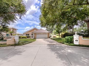 Single-story home with a two-car garage and manicured landscaping at 424 Cardiff Rd # 27, Venice, FL 34293