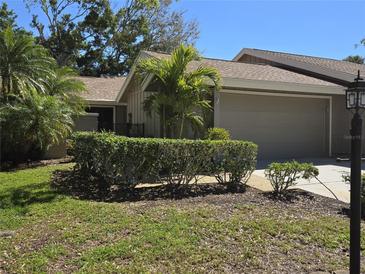 Charming home exterior with a well-manicured lawn and lush greenery at 4617 Forest Wood Trl # 8, Sarasota, FL 34241