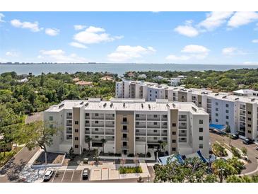 An exterior view of the condo community, with coastal views and parking at 1703 N Tamiami Trl # 302, Sarasota, FL 34234