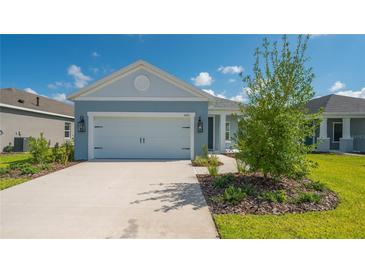 Two-car garage and manicured lawn at 14551 Skipping Stone Loop, Parrish, FL 34219