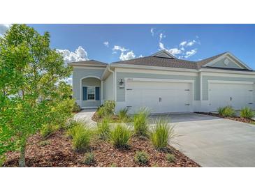 Two-car garage and charming front porch at 14705 Barefoot Ln, Parrish, FL 34219