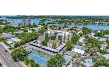 Aerial view of community, tennis courts, and parking at 6157 Midnight Pass Rd # G11, Sarasota, FL 34242