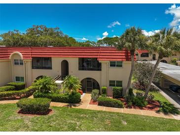 Condo building with red tile roof and lush landscaping at 213 Rubens Dr # D, Nokomis, FL 34275