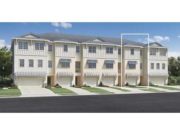 Three-story townhouses with attached garages and landscaping at 9964 Key Haven Rd, Seminole, FL 33777