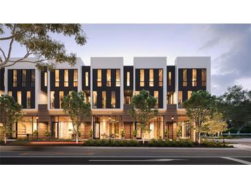 Modern townhouses with commercial spaces on the ground floor, illuminated at dusk at 1611 4Th St # B6, Sarasota, FL 34236