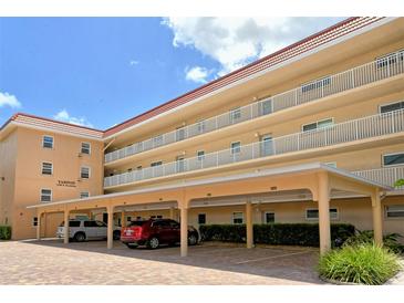 Condo building with parking and landscaping at 1350 N Portofino Dr # 310, Sarasota, FL 34242