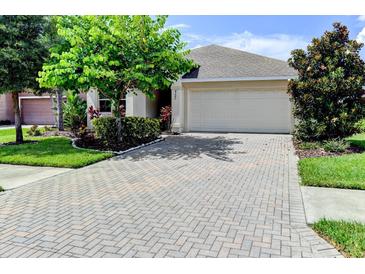 Single-Gathering home with a paved driveway and landscaping at 4247 Adelaar Dr, Sarasota, FL 34240