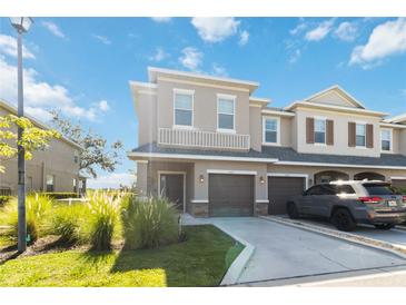 Two-story townhome with attached garage and landscaping at 1422 Grantham Dr, Sarasota, FL 34234