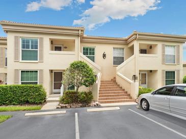 Two-story building exterior with stairs and parking at 4427 Longmeadow # 48, Sarasota, FL 34235