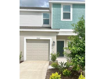 Two-story townhome with attached garage and landscaped front yard at 3063 Novara Ln, Lakewood Ranch, FL 34211