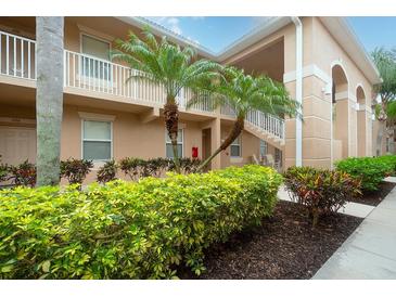 Exterior view of building with landscaping at 811 Fairwaycove Ln # 107, Bradenton, FL 34212