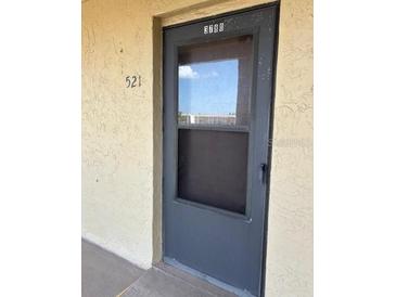 Exterior condo entry with a dark gray screen door at 3780 Lake Bayshore Dr # K-521, Bradenton, FL 34205