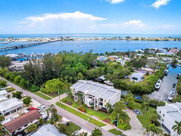 Aerial view of condo building near waterfront at 4212 126Th W St # 409, Cortez, FL 34215