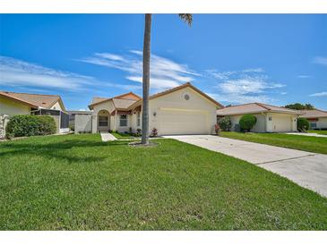 Single story home with attached garage and palm tree at 4223 Murfield E Dr, Bradenton, FL 34203