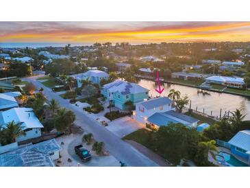 Captivating waterfront home with vibrant sunset views, lush landscaping, and convenient dock access, perfect for coastal living at 508 65Th St, Holmes Beach, FL 34217