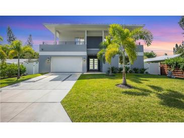 Modern two-story house with gray facade and palm trees at 2234 Hibiscus St, Sarasota, FL 34239