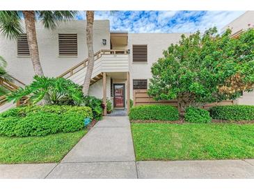 Condo building exterior with lush landscaping and a walkway at 184 Pineneedle Dr # 184, Bradenton, FL 34210
