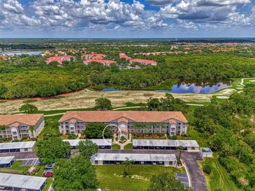 Aerial view of condo building with parking and golf course views at 8755 Olde Hickory Ave # 7105, Sarasota, FL 34238