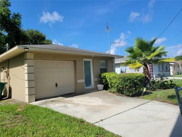 Charming home featuring a well-maintained front yard and a convenient attached single car garage at 707 13Th W St, Palmetto, FL 34221