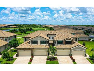 Stunning townhomes featuring tile roofs, brick-paved driveways, and lush landscaping within a gated golf course community at 18117 Gawthrop Dr # 103, Bradenton, FL 34211