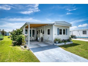 Mobile home with carport and landscaping at 6428 Fleetwood Ct, North Port, FL 34287