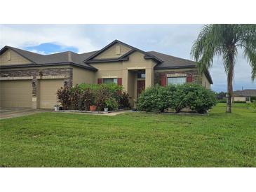 House exterior featuring stone accents and a two-car garage at 7410 64Th E St, Palmetto, FL 34221