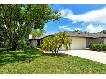 Front view of a house with lush landscaping at 7301 Ballantrae Pl # 27D, Sarasota, FL 34238