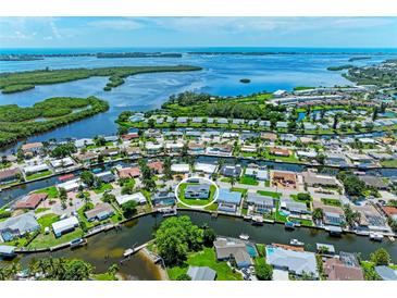Waterfront property with boat access in a coastal community, surrounded by canals and lush greenery at 5111 Coral Blvd, Bradenton, FL 34210