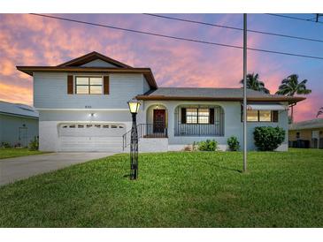 Charming two-story home boasting a manicured lawn and attached garage at 5111 Coral Blvd, Bradenton, FL 34210