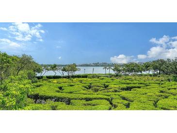 Lush green landscape with scenic water view in background at 826 Bayport Way # 826, Longboat Key, FL 34228