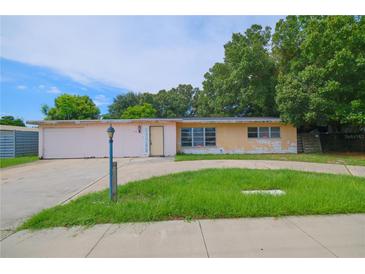 Ranch-style home with attached garage, needing cosmetic updates at 3123 Webber St, Sarasota, FL 34239