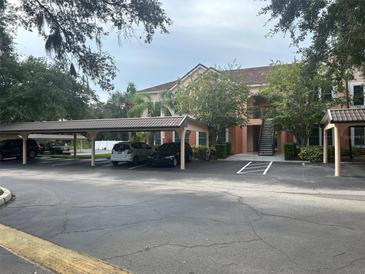 Condo building with covered parking and landscaping at 4102 Central Sarasota Pkwy # 922, Sarasota, FL 34238