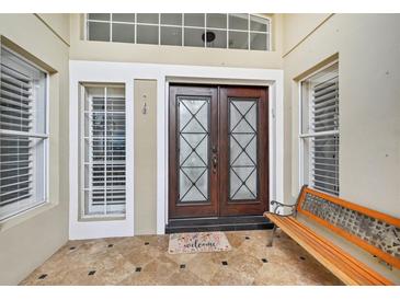 Inviting entryway with double doors and tiled floor at 7217 Churston Ln, University Park, FL 34201