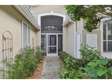 Inviting entryway with double doors, flanked by greenery and a cozy bench at 7217 Churston Ln, University Park, FL 34201