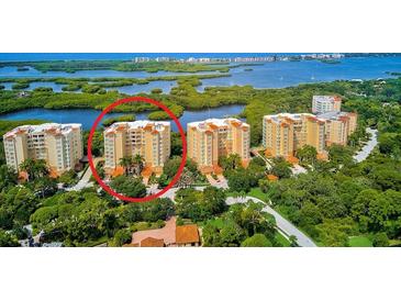 Aerial view of luxury condo building with water access at 393 N Point Rd # 503, Osprey, FL 34229