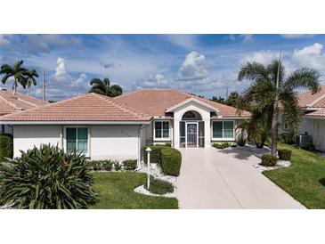 Single-story home with tile roof, landscaping, and driveway at 6772 Greenview Ln, Englewood, FL 34224