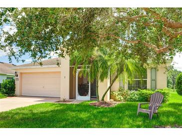 Charming home with a well-manicured lawn and a beautiful, mature tree providing ample shade at 9861 50Th Street E Cir, Parrish, FL 34219